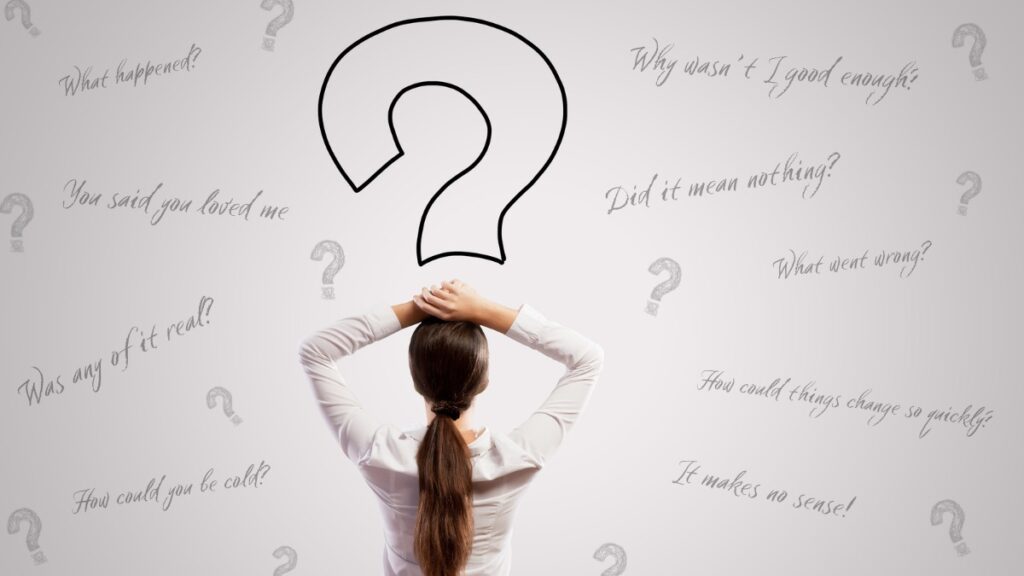 Woman staring at a wall of question marks